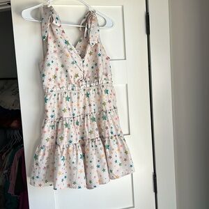 Cream star romper that ties over shoulders